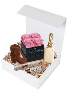 Boots Bubbly and Blossoms gift box with rose soap petals, cowgirl boot candle, champagne bottle cookie, bath salts, and lip balm
