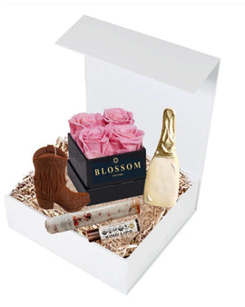 Boots Bubbly and Blossoms gift box with rose soap petals, cowgirl boot candle, champagne bottle cookie, bath salts, and lip balm
