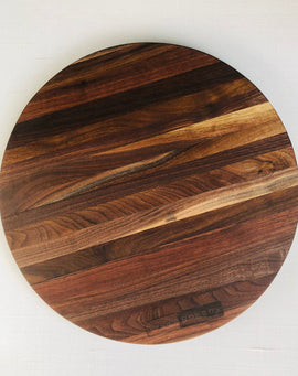 Round handcrafted walnut charcuterie board with rich natural wood grain by Nash Boards