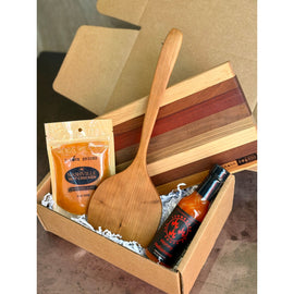 Nash Grill Gift Box with Petit Cutting Board, wooden flipper, Nashville Hot Chicken Spice, and Honey Habanero Hot Sauce arranged in kraft box