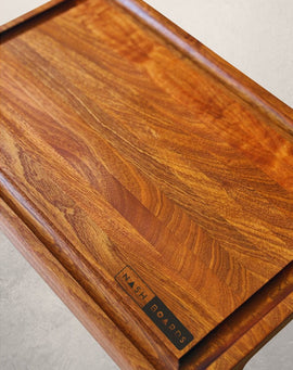 Handcrafted Noshville cutting board made from sapele hardwood with juice groove and handles by Nash Boards