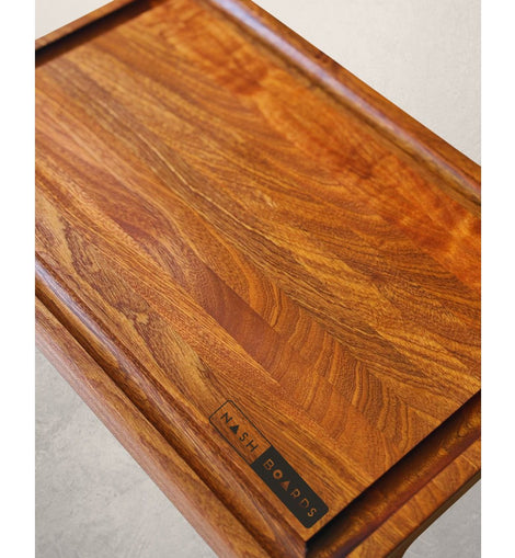 Handcrafted Noshville cutting board made from sapele hardwood with juice groove and handles by Nash Boards