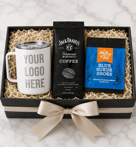 Gift set with a mug, coffee package, and tea package in a box on a marble surface.