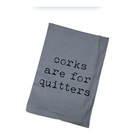 Grey flour-sack kitchen towel with the phrase “Corks Are For Quitters” printed in bold black text, folded and displayed for gift or kitchen use.