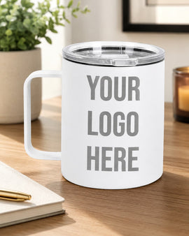 White mug with 'Your Logo Here' text on a wooden surface with a plant and candle in the background