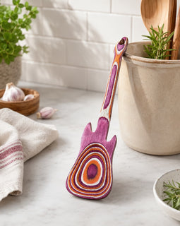 Colorful wooden spoon with a unique design on a kitchen counter.