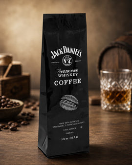 Jack Daniel's Tennessee Whiskey Coffee package on a wooden surface with coffee beans and a glass of whiskey.