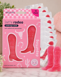 SpaLife rodeo-themed undereye mask packaging with pink cowgirl boot design on a marble surface.