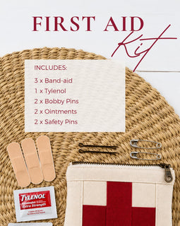 First aid kit with band-aids, Tylenol, bobby pins, and ointments on a woven mat.
