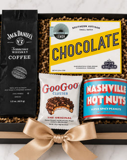 Gift box with coffee, chocolate, and snacks on a marble surface