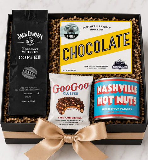 Gift box with coffee, chocolate, and snacks on a marble surface