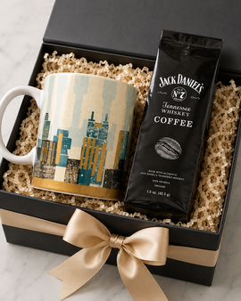 Gift set with mug and coffee package in a black box with a gold bow on a marble surface