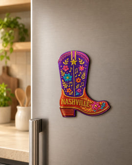 Colorful Nashville-themed cowboy boot magnet on a refrigerator door.