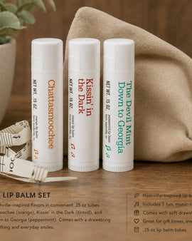 Nashville lip balm set with lip balms and a drawstring bag on a wooden surface.