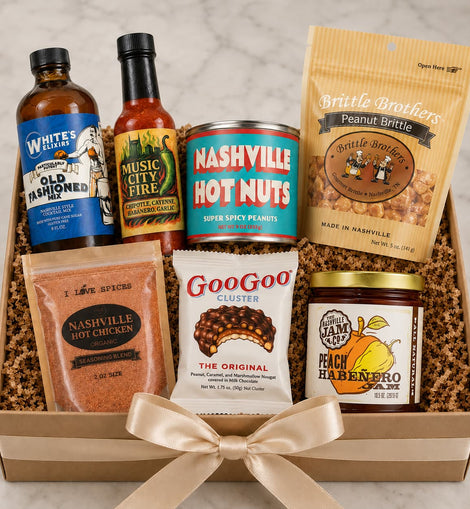 Assorted gift set with hot sauce, snack items, and a jar of jam in a box.