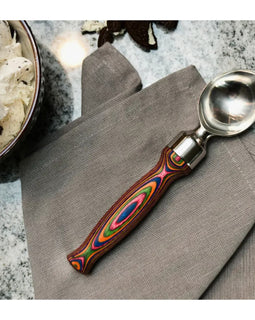 ice cream scoop with stainless steel head and layered rainbow Pakka wood handle, perfect for stylish dessert serving.