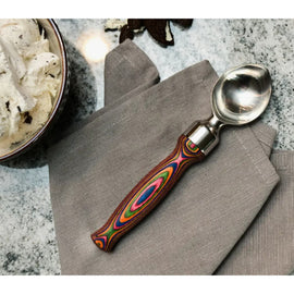 ice cream scoop with stainless steel head and layered rainbow Pakka wood handle, perfect for stylish dessert serving.