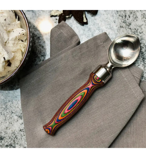 ice cream scoop with stainless steel head and layered rainbow Pakka wood handle, perfect for stylish dessert serving.