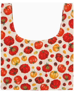 Reusable grocery bag with heirloom tomato print in red, yellow, and green, featuring wide handles and flat base, made from 100% cotton.