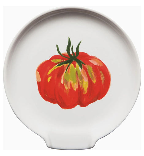 Stoneware spoon rest with colorful heirloom tomato print in red, orange, yellow, and green, featuring a center divot for resting utensils.